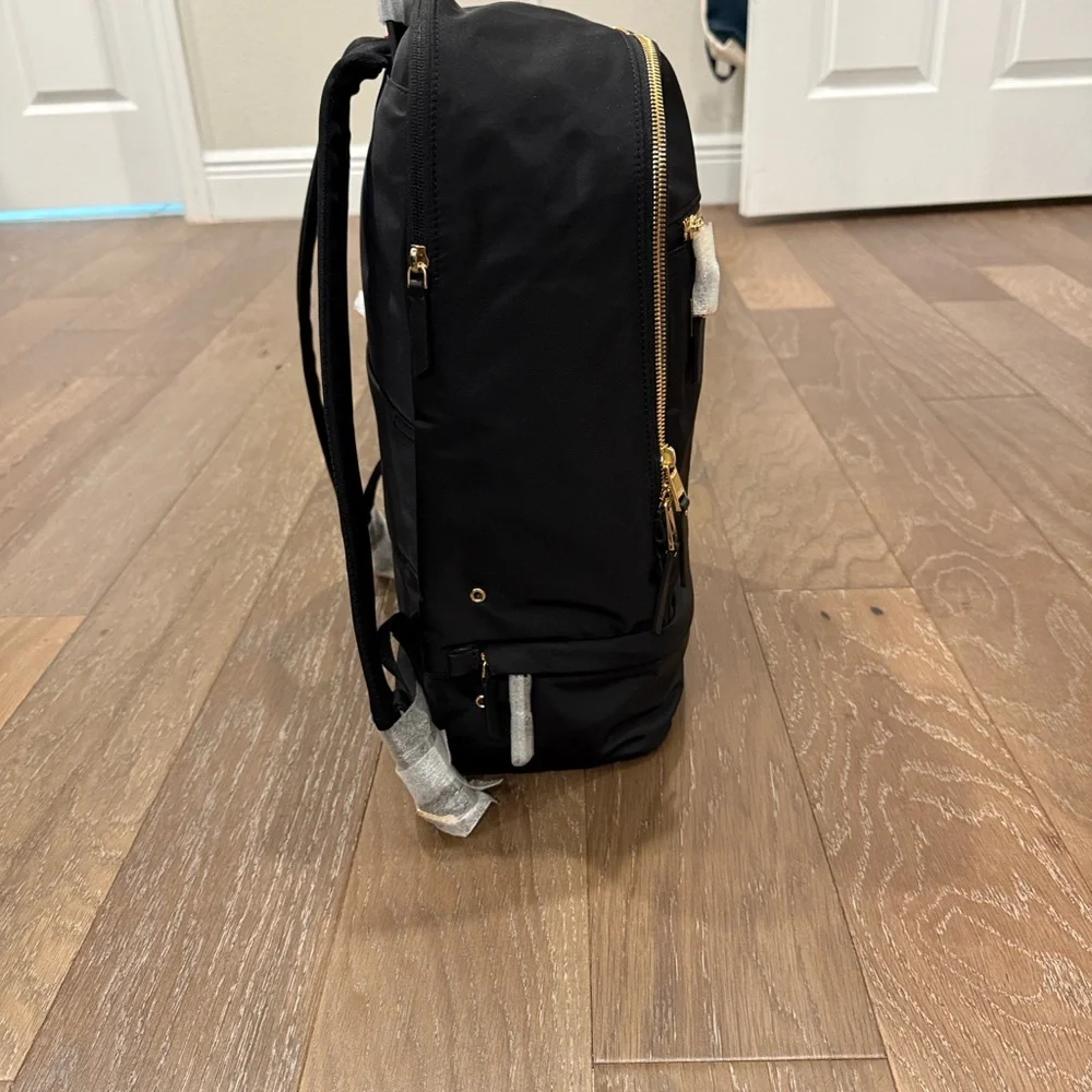 Tumi Backpack in Black with Gold Details and multiple components